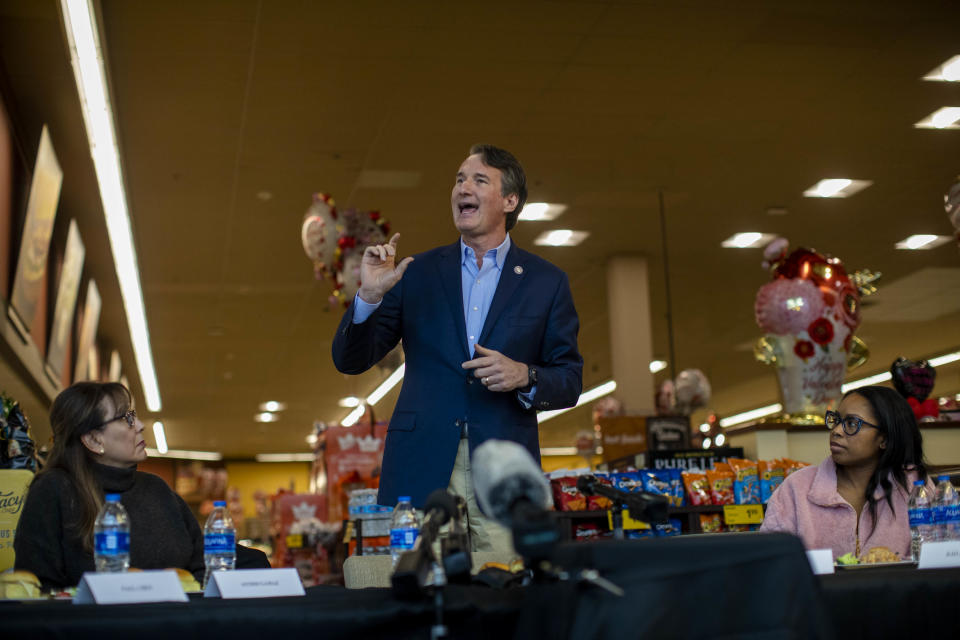 ALEXANDRIA, VA - FEBRUARY 3: Virginia Governor Glenn Youngkin heads a round table meeting at a Safeway grocery store in Alexandria, VA while Astrid Gamaz (left) and Shawntel Cooper (R) watch on February 3, 2022. (Photo by Robb Hill for The Washington Post via Getty Images)