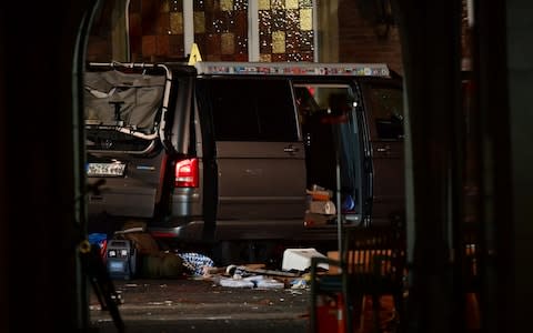 Police officers and forensic scientists stand by the van used in the incident - Credit:  Alexander Koerner/Getty Images