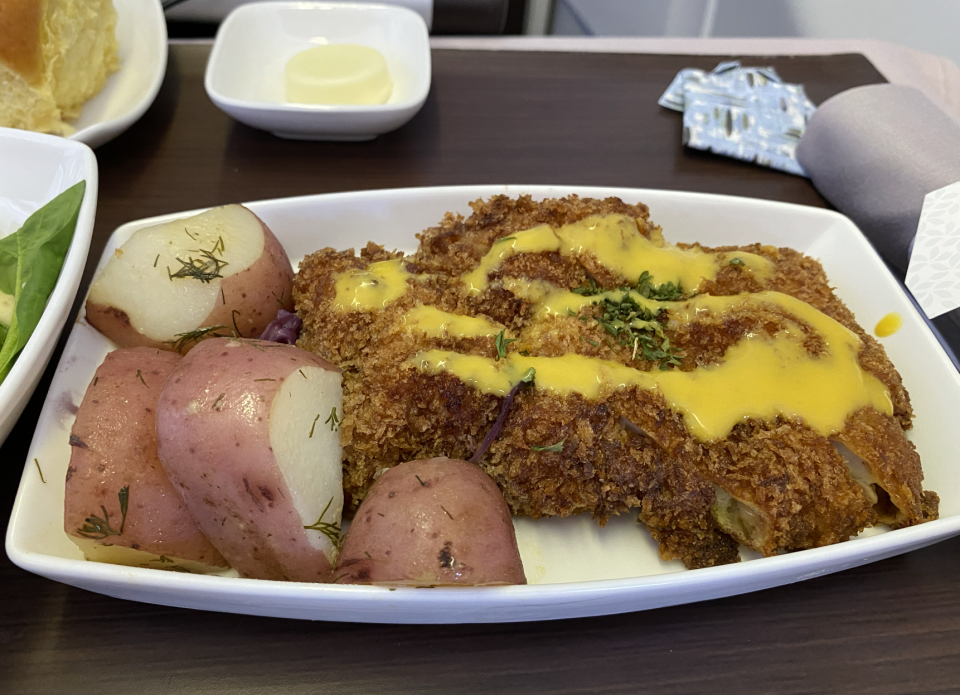 At Fête Hawaii, Chef Robynne Maii serves schnitzel made with local veal. Her in-flight version uses the more universally appealing chicken.