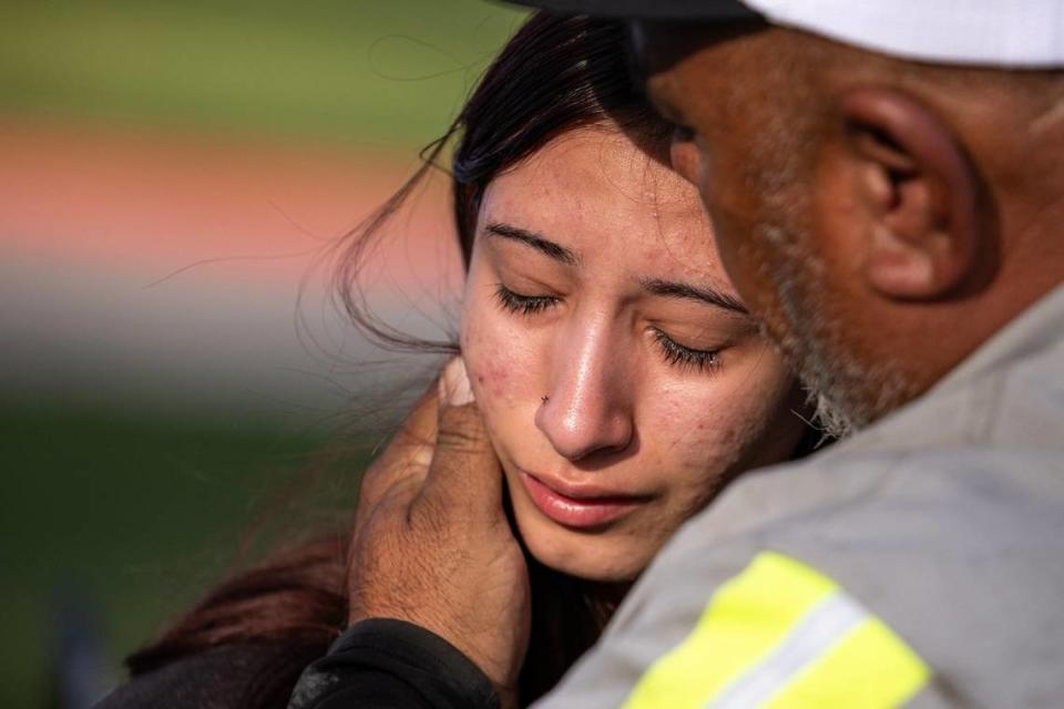 Freshman Amiah Barrera, 15, is comforted by her grandfather David Barrera after reuniting with her family at Arlington ISD Athletics Center on Wednesday, April 24, 2024. Bowie High School was put on lockdown after a shooting occurred on campus where one student was killed.