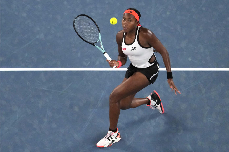 Coco Gauff, of the U.S. plays a forehand return to Emma Raducanu of Britain in their second round match at the Australian Open tennis championship in Melbourne, Australia, Wednesday, Jan. 18, 2023. (AP Photo/Aaron Favila)