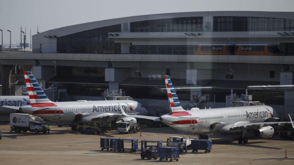 <div>American Airlines Group Inc. airplanes stand at passenger gates at Dallas/Fort Worth International Airport (DFW) near Dallas, Texas, U.S., on Thursday, Oct. 1, 2020. (Photographer: Patrick T. Fallon/Bloomberg via Getty Images)</div>