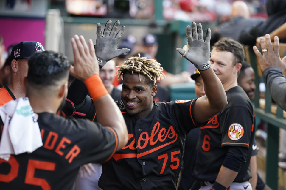 Baltimore Orioles' Domingo Leyba (75) celebrates in the dugout with teammates after hitting a home run during the second inning of a baseball game against the Los Angeles Angels Friday, July 2, 2021, in Anaheim. (AP Photo/Ashley Landis)