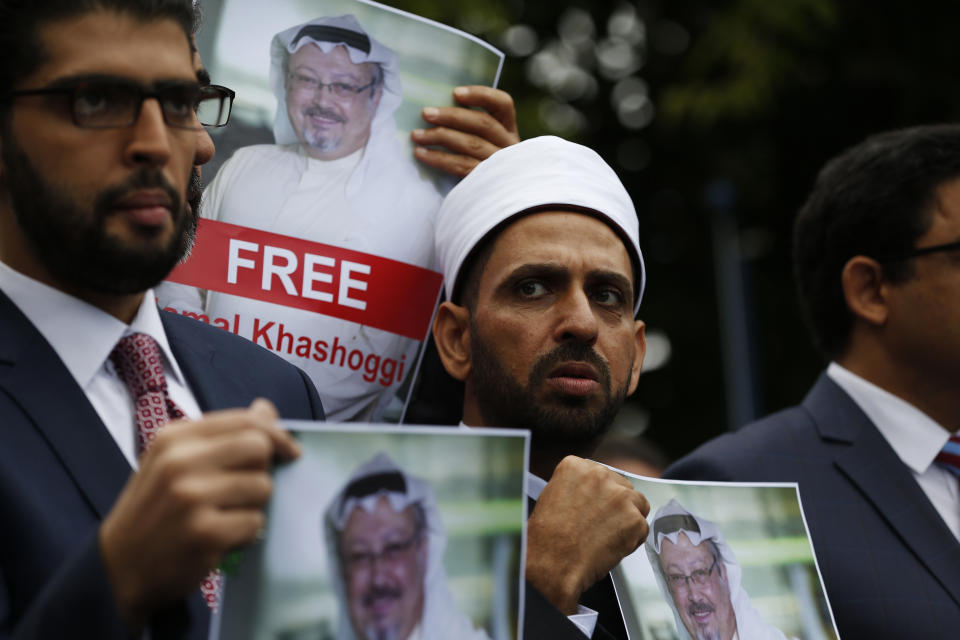 FILE - In this Monday, Oct. 8, 2018 file photo, members of the Turkish-Arab Journalist Association hold posters with photos of missing Saudi writer Jamal Khashoggi, as they hold a protest near the Saudi Arabia consulate in Istanbul. The disappearance of Khashoggi, during a visit to his country’s consulate in Istanbul last week, raises a dark question for anyone who dares criticize governments or speak out against those in power: Will the world have their back? (AP Photo/Lefteris Pitarakis, File)