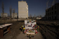 Pictures of victims are placed on a makeshift memorial for those killed on the place of a building demolished after being heavily damaged by an airstrike, one year ago, in Borodyanka, Ukraine, Thursday, March 2, 2023. On Friday, March 3, 2023, The Associated Press reported on stories circulating online incorrectly claiming the U.S. only supports Ukraine through donated military equipment, not cash assistance. (AP Photo/Vadim Ghirda)