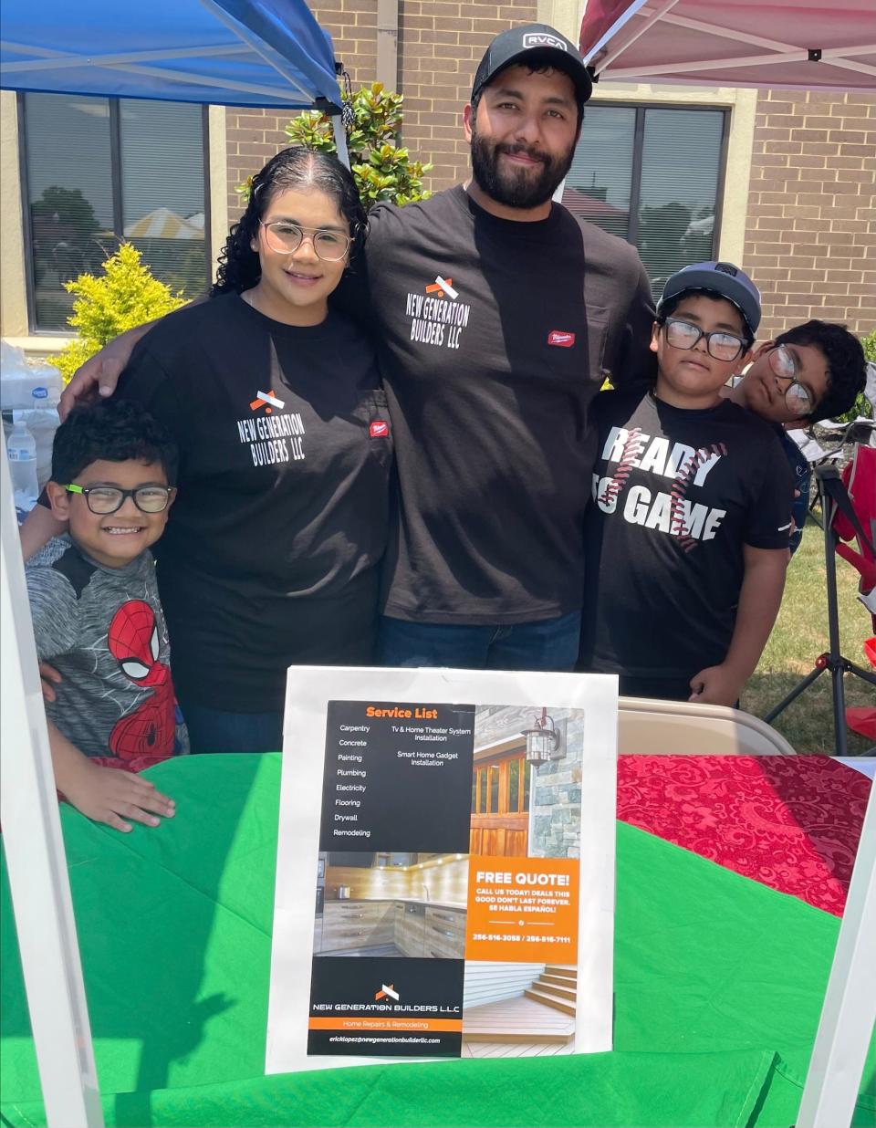 Erika and Erick Garcia stand with sons Max, Oliver, and Elizer in front of their booth at the Latino Festival at Northeast Alabama Community College on June 10, 2023.