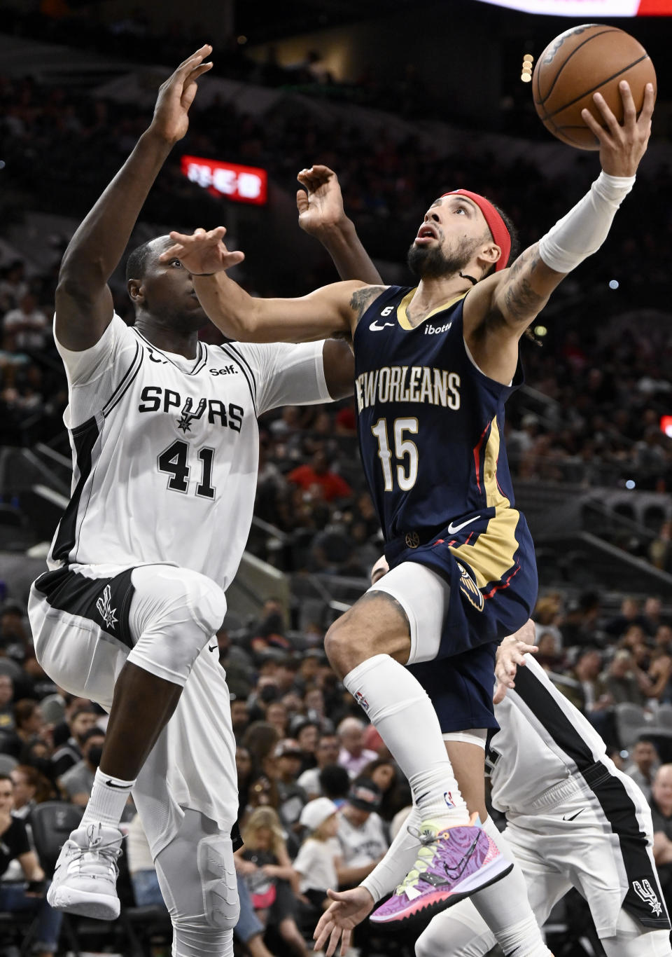 New Orleans Pelicans' Jose Alvarado (15) shoots against San Antonio Spurs' Gorgui Dieng during the second half of a preseason NBA basketball game, Sunday, Oct. 9, 2022, in San Antonio. (AP Photo/Darren Abate)