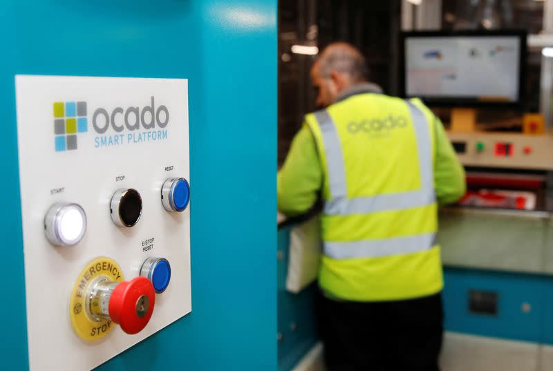 Ocado robots are seen inside a warehouse in Erith