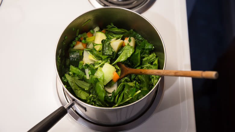 leafy greens cooking in saucepan 