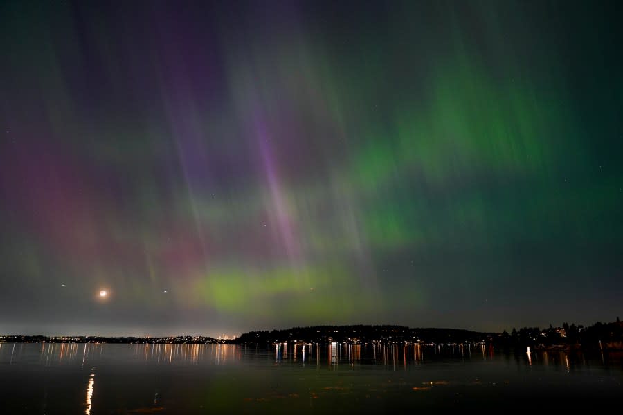 The northern lights, or aurora borealis, are visible over Lake Washington, in Renton, Wash., on Friday evening, May 10, 2024. (AP Photo/Lindsey Wasson)