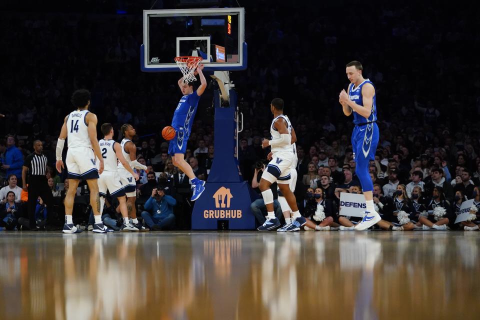 Creighton's Ryan Kalkbrenner (11) dunks in front of Villanova's Justin Moore, third from front left, Collin Gillespie (2) and Caleb Daniels (14) during the first half of an NCAA college basketball game in the final of the Big East conference tournament Saturday, March 12, 2022, in New York. (AP Photo/Frank Franklin II)