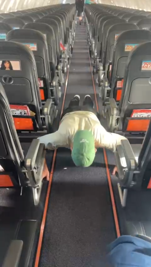 Man doing press ups on an aeroplane