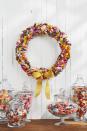 <p>Sure, you may want to eat all the Halloween candy you can, but it makes for the perfect decoration too. Case in point? This very sweet wreath.</p><p><strong>Make the Candy Wreath: </strong>Gather an assortment of old-fashioned candies in autumnal shades such as yellow, orange, and magenta. Wrap a 14-inch foam wreath form in white ribbon. Attach candy with hot-glue, layering and overlapping as you go. Finish with a yellow burlap bow.</p>