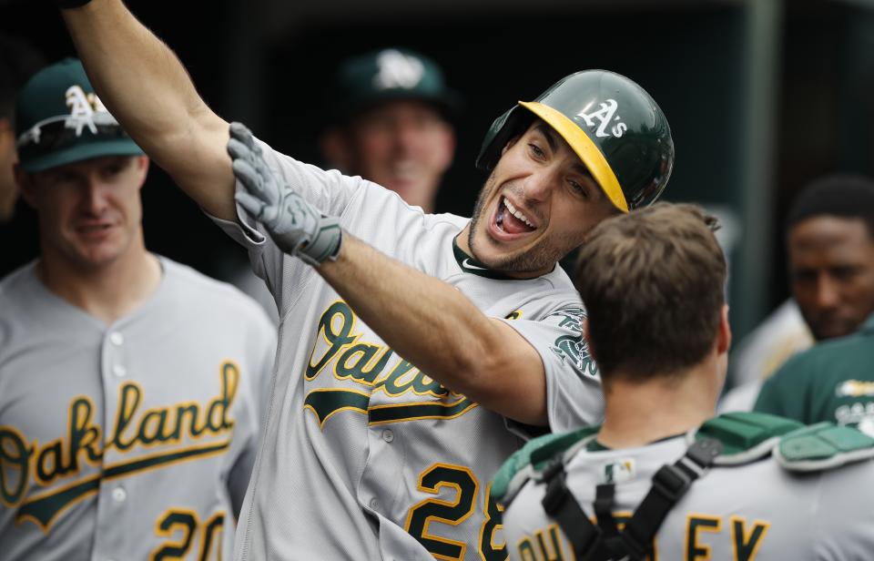 Oakland Athletics' Matt Olson celebrates with teammates after hitting a solo home run during the sixth inning of a baseball game against the Detroit Tigers, Thursday, May 16, 2019, in Detroit. (AP Photo/Carlos Osorio)