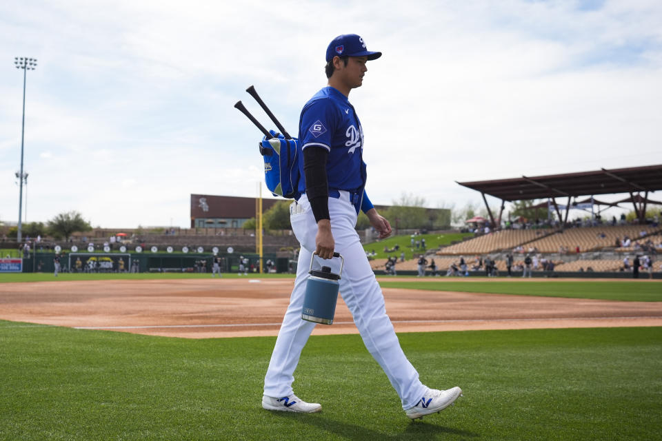 Los Angeles Dodgers designated hitter Shohei Ohtani walks to the dugout before a spring training baseball game against the Chicago White Sox in Phoenix, Tuesday, Feb. 27, 2024. (AP Photo/Ashley Landis)