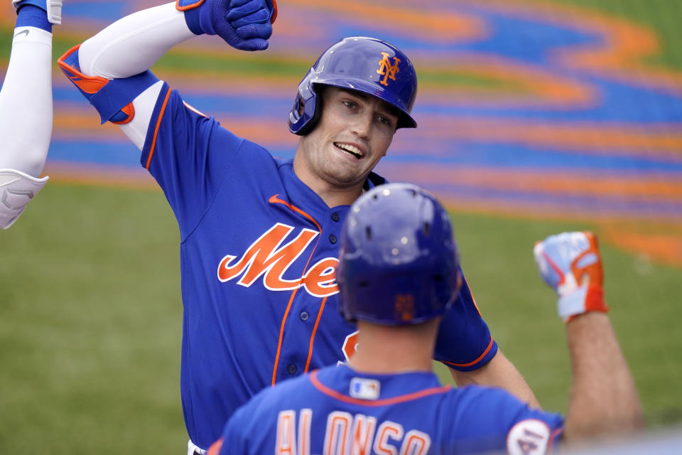 New York Mets' Brandon Nimmo, left, celebrates with Pete Alonso after hitting a solo home run during the first inning of a spring training baseball game against the Washington Nationals, Thursday, March 4, 2021, in Port St. Lucie, Fla. (AP Photo/Lynne Sladky)