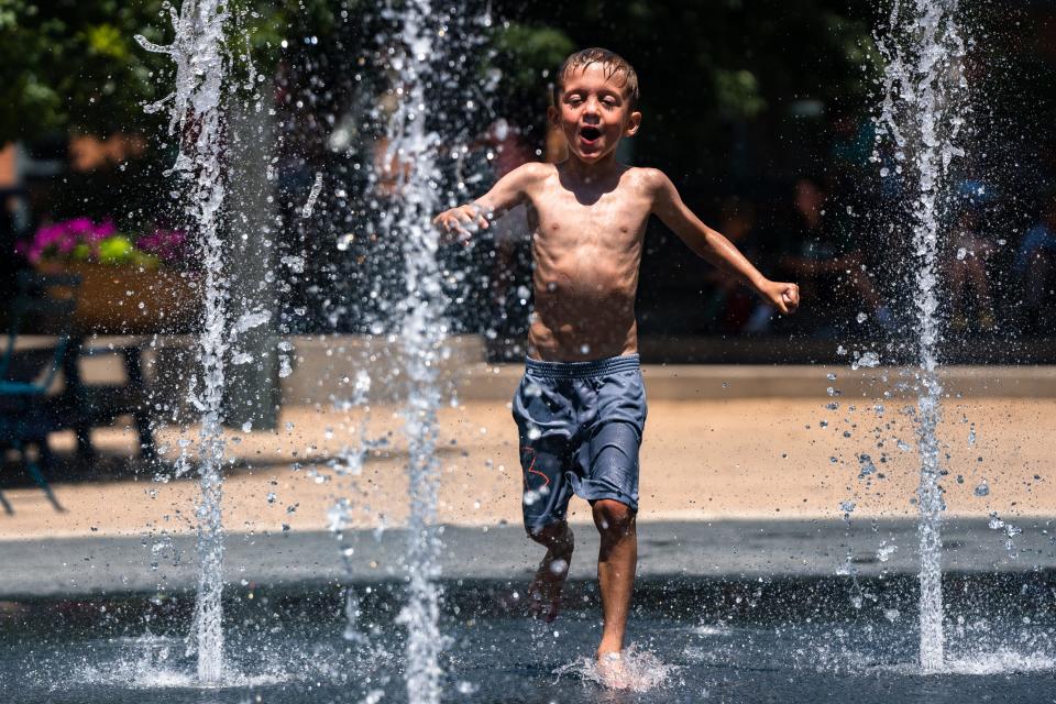 Kade McArdle, 5, plays in a splash pad on a hot day in downtown Fort Collins on July 17, 2023.