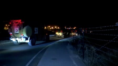 A Turkish armored military convoy is seen driving along the border with Syria, in Akcakale, Turkey