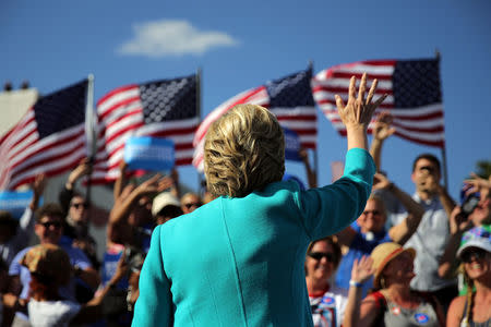 Hillary Clinton waves as she leaves a campaign rally in Tampa, Florida. REUTERS/Carlos Barria