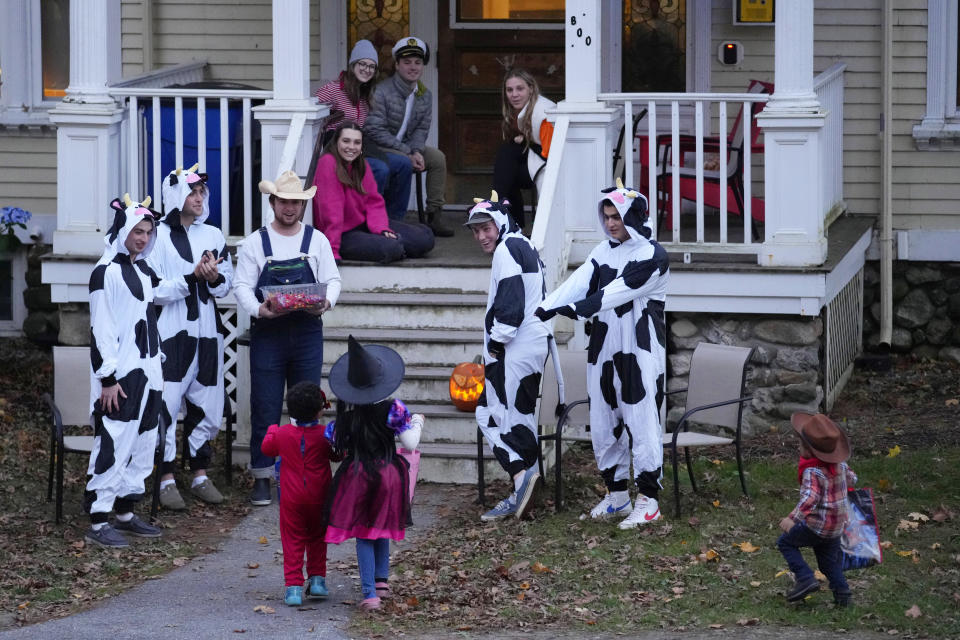 Bates College students welcome trick-or-treaters on Halloween, Tuesday, Oct. 31, 2023, in Lewiston, Maine. The college hosted a campus-wide Halloween route for youngsters on a candy collecting mission to help lift spirits in the wake of last week's mass shootings.. (AP Photo/Robert F. Bukaty)