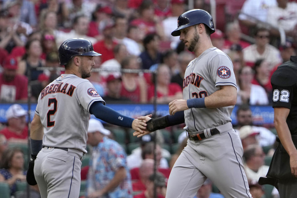 Houston Astros' Kyle Tucker and Alex Bregman (2) celebrate after scoring during the second inning of a baseball game against the St. Louis Cardinals Thursday, June 29, 2023, in St. Louis. (AP Photo/Jeff Roberson)