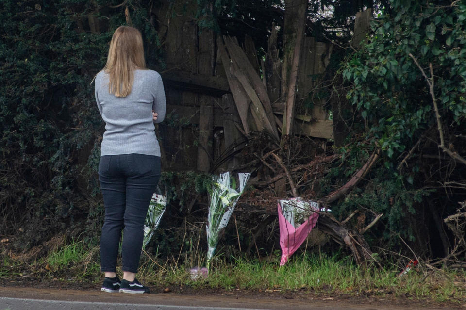 People leave floral tributes at the scene in January last year. (SWNS)