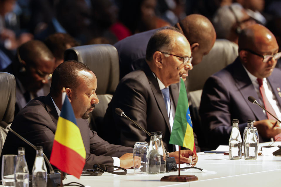 Ethiopian President Abiy Ahmed left, attends a meeting during the 2023 BRICS Summit at the Sandton Convention Centre in Johannesburg Thursday, Aug. 24, 2023. (Marco Longari/Pool via AP)