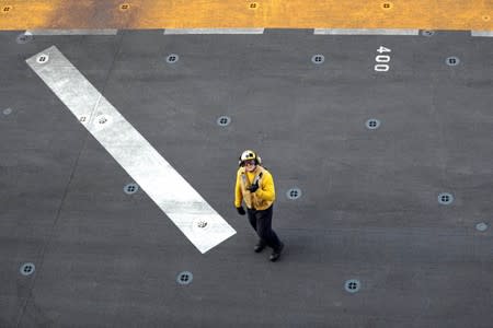 A U.S. sailor is seen on the deck of the USS Boxer (LHD-4) in the Arabian Sea off Oman