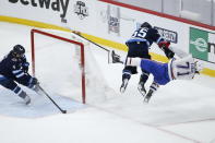 Winnipeg Jets' Mark Scheifele (55) hits Montreal Canadiens' Jake Evans (71) after Evans scored an empty-net goal during the third period of Game 1 of an NHL hockey Stanley Cup second-round playoff series Wednesday, June 2, 2021, in Winnipeg, Manitoba. (John Woods/The Canadian Press via AP)