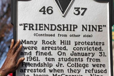 Willie E. McCleod, a member of the Friendship Nine, touches a historical marker next to the Five & Dine diner in Rock Hill, South Carolina, December 17, 2014. REUTERS/Jason Miczek