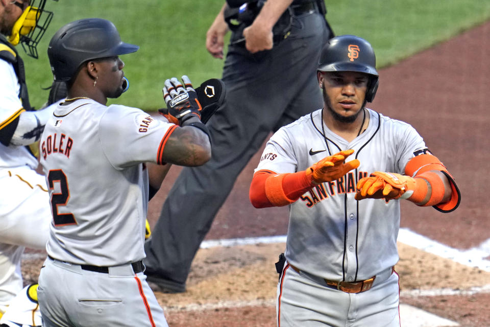 San Francisco Giants' Thairo Estrada, right, celebrates with Jorge Soler (2) as he returns to the dugout after hitting a two-run home run off Pittsburgh Pirates starting pitcher Martín Pérez during the fifth inning of a baseball game in Pittsburgh, Tuesday, May 21, 2024. (AP Photo/Gene J. Puskar)