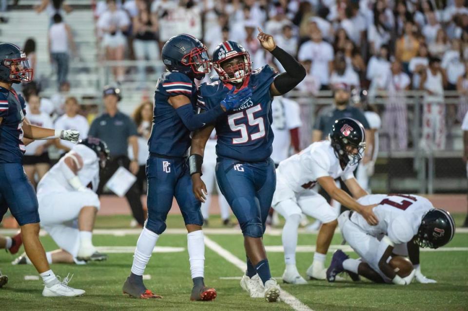 The Pleasant Grove Eagles’ Roman Patterson (55) celebrates after tackling the Laguna Creek Cardinals’ Tariq Booth (17) in the first half of the game on Friday, Sept. 8, 2023, at Sheldon High School.