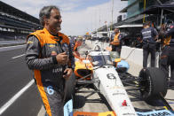 Juan Pablo Montoya, of Colombia, walks around his car during practice for the Indianapolis 500 auto race at Indianapolis Motor Speedway, Tuesday, May 17, 2022, in Indianapolis. (AP Photo/Darron Cummings)