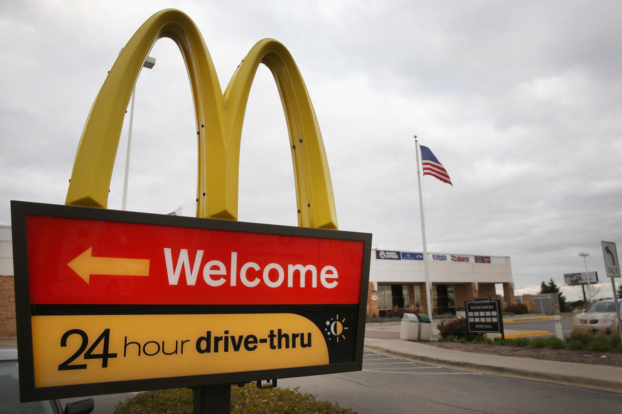 DES PLAINES, IL - OCTOBER 24:  A sign directs customers to the drive-thru at a McDonald's restaurant on October 24, 2013 in Des Plaines, Illinois. McDonald's has announced it will make changes to its low-priced Dollar Menu, which includes items like coffee, small fries, hamburgers and apple pies. The new menu, dubbed the Dollar Menu and More, will offer some higher priced options such as the grilled Onion Cheddar Burger and a McChicken sandwich.  (Photo by Scott Olson/Getty Images)