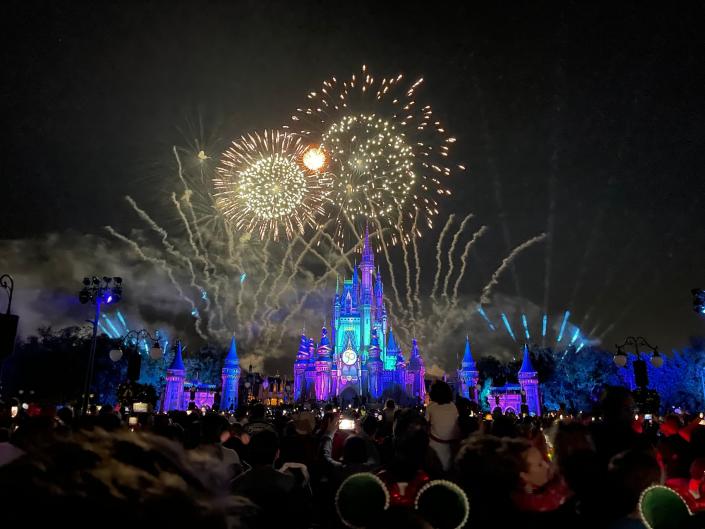 christmas party fireworks going off over the castle at magic kingdom