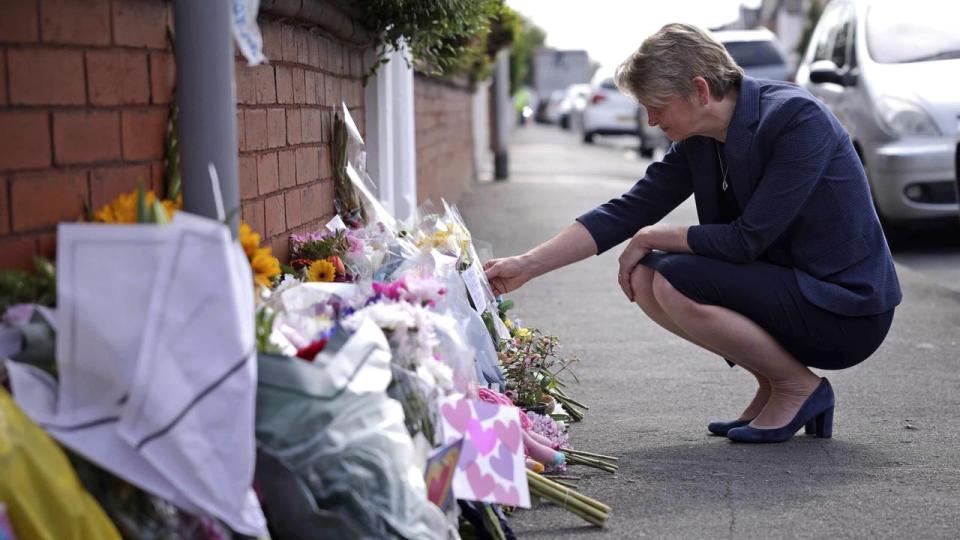 British Home Secretary Yvette Cooper lays flowers