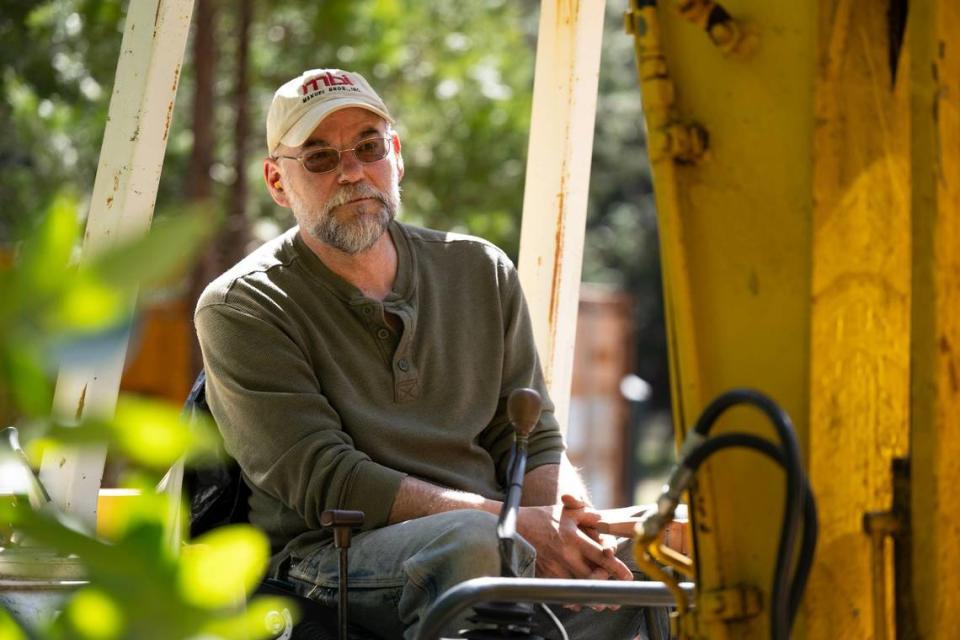 Homeowner Hans Shillinger works to clear trees from his property last month near Nevada City. The state is requiring companies provide discounts for property insurance, if the property owners can show they have mitigated for wildfire risk.