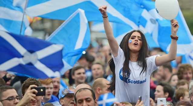 A young women joins Yes activists as they gather in George Square in Glasgow. Photo: Getty Images