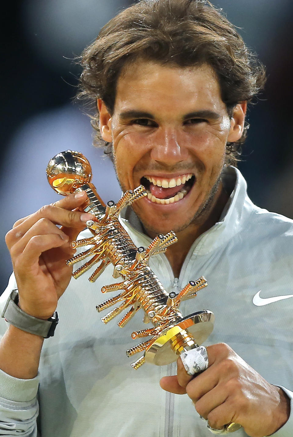 Rafael Nadal from Spain poses for photographers with his trophy, after winning his Madrid Open tennis tournament, men's final match against Kei Nishikori from Japan in Madrid, Spain, Sunday, May 11, 2014. (AP Photo/Andres Kudacki)