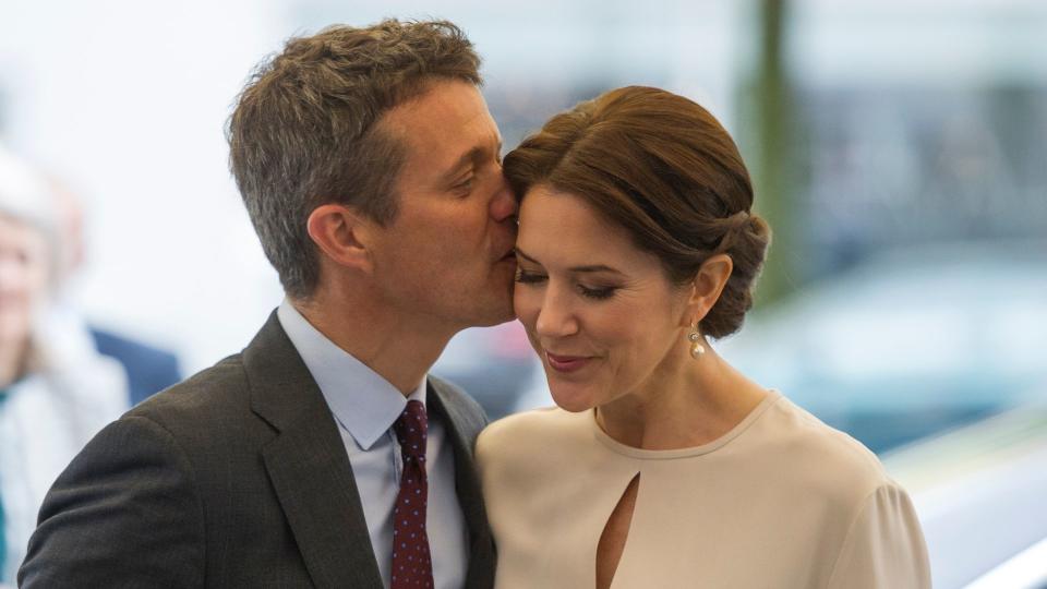 husband kissing wife on cheek 