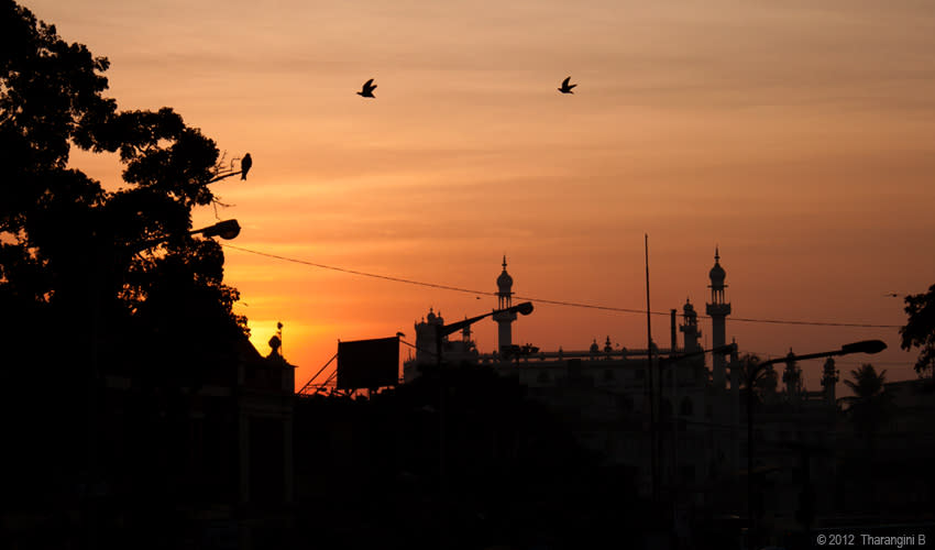 Morning dawns over a bustling market area of the city.