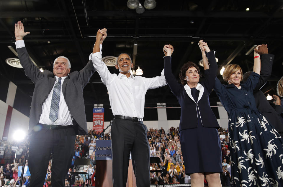 Former President Barack Obama, second from left, cheers at a rally in support of candidate for Senate Jacky Rosen, second from right, Clark County Commission Chair and Democratic gubernatorial candidate Steve Sisolak, left, and Susie Lee, Democratic candidate for Nevada's third congressional district, right, and other Nevada Democrats, Monday, Oct. 22, 2018, in Las Vegas. (AP Photo/John Locher)