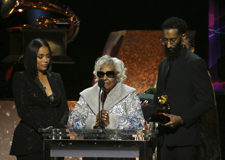 Lauren London, from left, Margaret Boutte, and Samiel Asghedom accept the award for best rap performance for "Racks in the Middle" on behalf of Nipsey Hussle at the 62nd annual Grammy Awards on Sunday, Jan. 26, 2020, in Los Angeles. (Photo by Matt Sayles/Invision/AP)