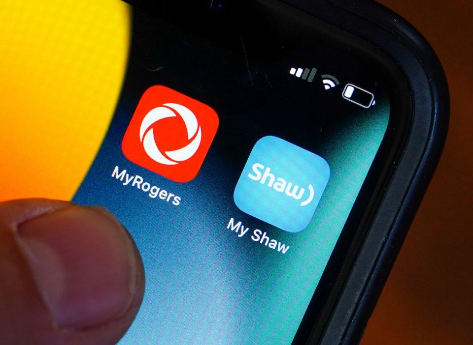 Rogers and Shaw applications are pictured on a cellphone in Ottawa on Monday, May 9, 2022. The Competition Bureau says is seeking to block Rogers Communications Inc.'s proposed $26-billion acquisition of Shaw Communications Inc.