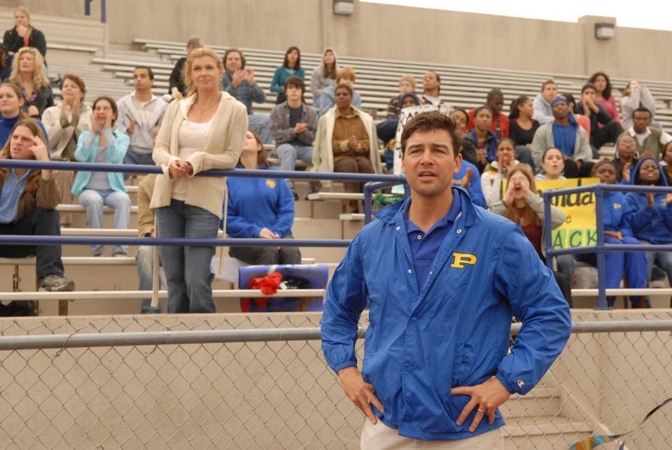 Connie Britton, standing center left, as Tami Taylor, and Kyle Chandler, foreground, as Eric Taylor in the NBC series “Friday Night Lights.”