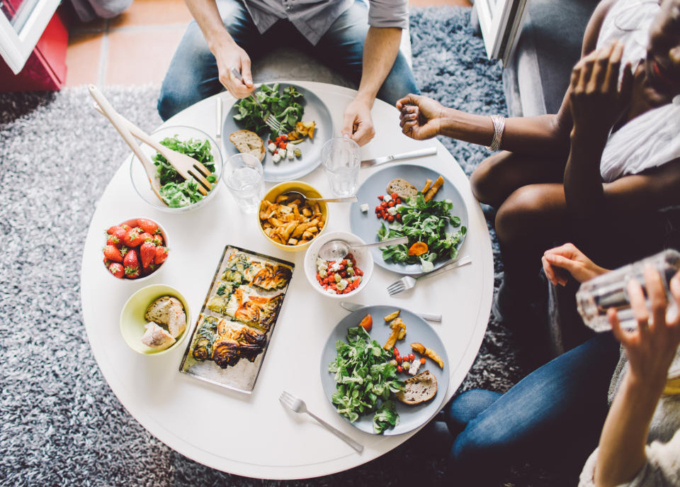 Friends enjoying vegetarian lunch at home. (Getty Images)