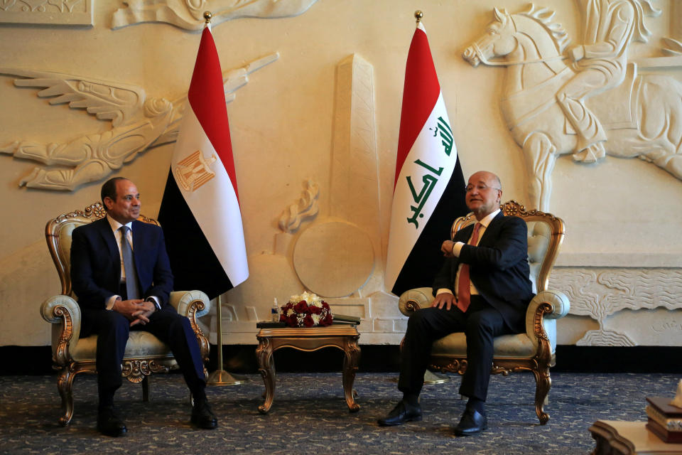 Iraqi President Barham Salih, right, meets with visiting Egypt's President Abdel Fattah el-Sissi, upon the latter's arrival at an airport in Baghdad, Iraq, Sunday, June 27, 2021. (AP Photo/Khalid Mohammed)