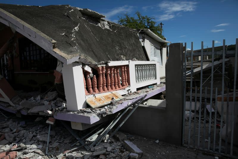 A house that collapsed on its foundation is seen after an earthquake in Guanica