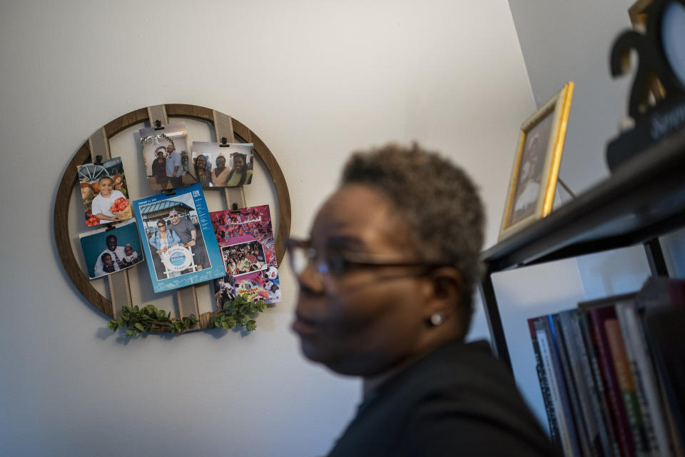 Melanese Marr-Thomas talks about the photographs of her late husband, Charles Thomas, which decorate her living room wall in District Heights, Md., on Wednesday, Sept. 21, 2022. He felt doctors were quick to blame any ailments solely on his weight, but slow to listen to his symptoms or examine other causes. He eventually gave up on seeking medical care for a long time because he was tired of feeling judged. (AP Photo/Wong Maye-E)