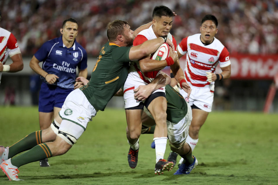 Japan's Yu Tamura (10) runs against South Africa's Duane Vermeulen (8) during a rugby match at Kumagaya Rugby Stadium Friday, Sept. 6, 2019, in Saitama, Japan. (AP Photo/Eugene Hoshiko)